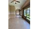 Extended view of the sun room featuring tiled flooring, ceiling fans, and multiple windows at 2312 Indigo Island St, Henderson, NV 89044