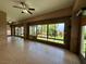 Spacious sun room with tile flooring, ceiling fans, and large windows offering backyard views at 2312 Indigo Island St, Henderson, NV 89044