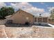 Backyard featuring desert landscaping, patio and a cozy sunroom at 2631 Bed Knoll Ct, North Las Vegas, NV 89031