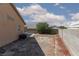 Spacious backyard area with block wall, tree and air conditioning unit, offering potential for landscaping and outdoor activities at 2631 Bed Knoll Ct, North Las Vegas, NV 89031