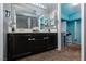 Bathroom featuring a double vanity, large mirror, and access to a closet at 2631 Bed Knoll Ct, North Las Vegas, NV 89031