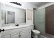 A bathroom featuring a white vanity, neutral walls, and tiled shower at 2631 Bed Knoll Ct, North Las Vegas, NV 89031