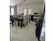 Dining room with table and four chairs, open plan feel with an office in background at 2631 Bed Knoll Ct, North Las Vegas, NV 89031