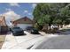 Charming single-story home with a two-car garage and well-maintained front yard and cars at 2631 Bed Knoll Ct, North Las Vegas, NV 89031