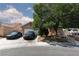 A lovely single-story home features a well-kept lawn, mature tree, and a driveway with parking at 2631 Bed Knoll Ct, North Las Vegas, NV 89031