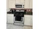 Close up of a kitchen with stainless steel appliances and granite countertops at 2631 Bed Knoll Ct, North Las Vegas, NV 89031