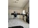 Bright kitchen with white cabinets, stainless appliances, and tiled flooring at 2631 Bed Knoll Ct, North Las Vegas, NV 89031