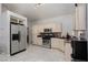 Well-lit kitchen featuring stainless steel appliances, cream cabinets, and tiled floors at 2631 Bed Knoll Ct, North Las Vegas, NV 89031