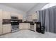 Bright kitchen area features cream cabinets, stainless steel appliances, and ample counter space at 2631 Bed Knoll Ct, North Las Vegas, NV 89031