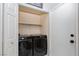 Laundry area featuring modern washer and dryer units with shelving for storage at 2631 Bed Knoll Ct, North Las Vegas, NV 89031