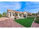 Exterior view of backyard featuring artificial turf, rock landscaping, and covered patio at 2725 Byron Dr, Las Vegas, NV 89134