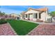 Backyard features include artificial turf, rock landscaping and patio dining at 2725 Byron Dr, Las Vegas, NV 89134