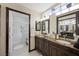 Luxurious bathroom with a dual sink vanity, and a large shower with glass doors at 2725 Byron Dr, Las Vegas, NV 89134