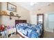 Cozy bedroom featuring a blue patterned quilt, artwork, and wood furnishings at 2725 Byron Dr, Las Vegas, NV 89134