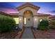 Inviting front entrance features an arched portico, decorative wreath, and desert landscaping at 2725 Byron Dr, Las Vegas, NV 89134