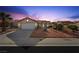 Charming one-story home with low-maintenance desert landscaping and a two-car garage at dusk at 2725 Byron Dr, Las Vegas, NV 89134