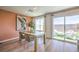 Elegant dining room with a wooden table, comfortable seating, and sliding glass doors to the patio at 3402 La Cura Ave # Lot 69, Las Vegas, NV 89141