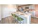 Kitchen island with bar stool seating, ample counter space, and modern gray cabinetry at 3402 La Cura Ave # Lot 69, Las Vegas, NV 89141