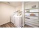 Efficient laundry room featuring modern appliances, built-in shelving, and durable flooring at 3402 La Cura Ave # Lot 69, Las Vegas, NV 89141