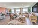 Open-concept living room featuring modern furniture and sliding glass doors to the backyard at 3402 La Cura Ave # Lot 69, Las Vegas, NV 89141