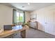 Bright office space with a sleek desk, accent cabinet, and a view from the window at 3402 La Cura Ave # Lot 69, Las Vegas, NV 89141