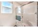 Modern shower with glass doors, tiled walls, a built-in seat, and natural light from the window at 3402 La Cura Ave # Lot 69, Las Vegas, NV 89141