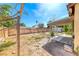 View of the home's backyard with a partially covered patio, wood fence, and open space at 4100 Montebello Ave, Las Vegas, NV 89110