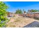 Wide shot of the property's backyard, showing a partially shaded yard, a storage shed, and tall fencing at 4100 Montebello Ave, Las Vegas, NV 89110