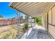 Backyard with a patio cover, weathered pergola and mature trees at 4100 Montebello Ave, Las Vegas, NV 89110