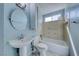 Well-lit bathroom featuring a sink, toilet, and bathtub with tile surround at 4100 Montebello Ave, Las Vegas, NV 89110