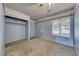A simple bedroom with carpet floors, a window view, and a built-in closet at 4100 Montebello Ave, Las Vegas, NV 89110