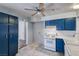 Traditional kitchen with blue cabinets, tile floors, and white appliances at 4100 Montebello Ave, Las Vegas, NV 89110