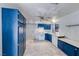 A well-lit kitchen boasts marble floors, blue cabinets, and essential appliances at 4100 Montebello Ave, Las Vegas, NV 89110