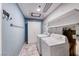 Functional laundry room with modern appliances and overhead shelving for added storage at 4100 Montebello Ave, Las Vegas, NV 89110