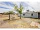 Backyard featuring a brick BBQ pit, dirt landscaping, and the side of the home at 419 National St, Henderson, NV 89015