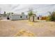 Wide shot of the backyard featuring a brick BBQ pit, shed, and house at 419 National St, Henderson, NV 89015