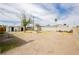 Large backyard featuring dirt landscaping, some grass, brick BBQ pit and sheds at 419 National St, Henderson, NV 89015