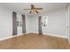 A cozy bedroom featuring wood floors, two windows, and neutral colored walls at 419 National St, Henderson, NV 89015
