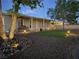 Charming home featuring a landscaped front yard with a cozy bench and decorative outdoor lighting at 419 National St, Henderson, NV 89015