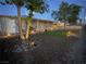 Evening view of front yard with rock landscaping, artificial turf, and charming pathway lighting at 419 National St, Henderson, NV 89015