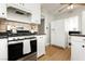 Cozy kitchen features stainless steel appliances, laminate flooring, and updated cabinetry at 419 National St, Henderson, NV 89015