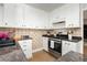 Well-equipped kitchen features stainless steel appliances, stylish countertops and tiled backsplash at 419 National St, Henderson, NV 89015