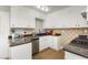 Efficient kitchen features white cabinets, granite countertops, and stainless steel appliances at 419 National St, Henderson, NV 89015