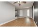 Bright living room with modern ceiling fan, vinyl flooring, and views into the tiled entryway at 419 National St, Henderson, NV 89015