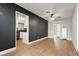 Spacious living room showcasing the vinyl flooring, dark accent wall, and access to the kitchen at 419 National St, Henderson, NV 89015