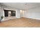 Bright and airy living room with laminate floors, light gray walls, and open doorway at 419 National St, Henderson, NV 89015
