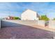 Flat backyard features a gravel ground cover and block fence for privacy at 4195 Story Rock St, Las Vegas, NV 89115