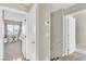 Light-filled hallway features carpet, paint, and doors leading to bedrooms at 4195 Story Rock St, Las Vegas, NV 89115