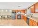 Updated kitchen with black appliances, laminate flooring, and a cozy breakfast nook at 4195 Story Rock St, Las Vegas, NV 89115
