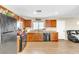 Clean kitchen with laminate flooring, black appliances, and a connection to the living area at 4195 Story Rock St, Las Vegas, NV 89115